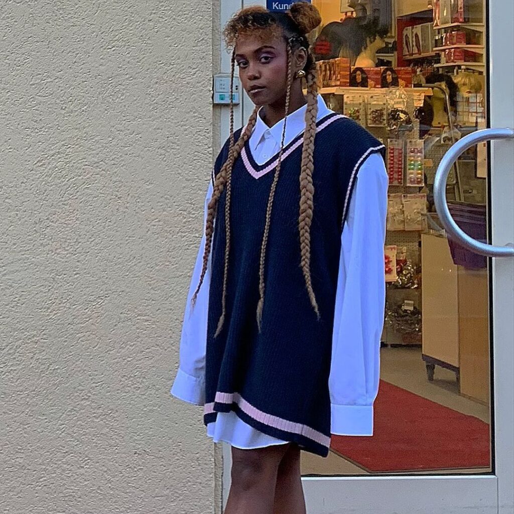 Photo of a person wearing a fall vintage outfit with a preppy knit vest