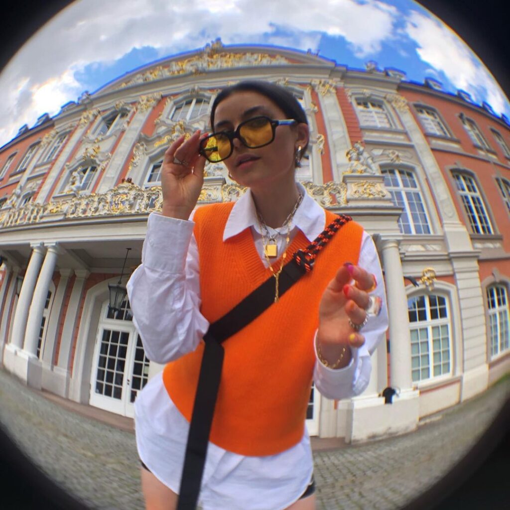 Photo of a person wearing a fall vintage outfit with a preppy knit vest